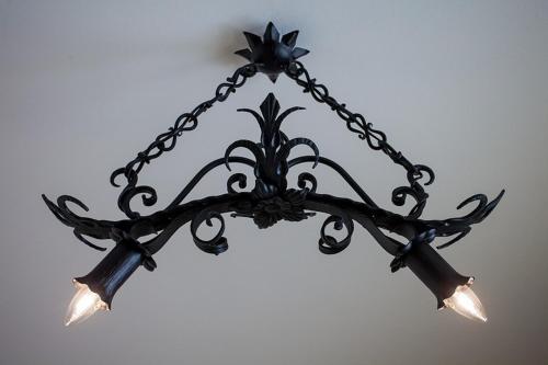 a black chandelier hanging on a wall at Willa Litworówka III Wellness&SPA in Poronin