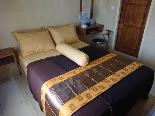 a large bed in a room with at Villagio Hotel in Pameungpeuk