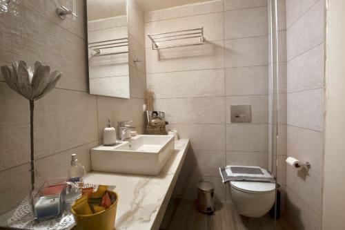 a white bathroom with a sink and a toilet at Chronis Family Villas in Krousón