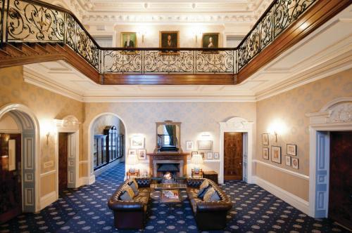 
a living room filled with furniture and a stair case at Champneys Tring in Tring
