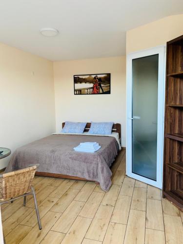 a bedroom with a bed and a sliding glass door at Mirage Hotel in Zatoka