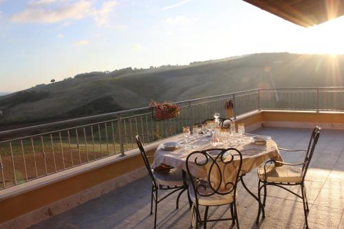 a table and chairs on a balcony with a view at Belvedere Sasso in Sasso