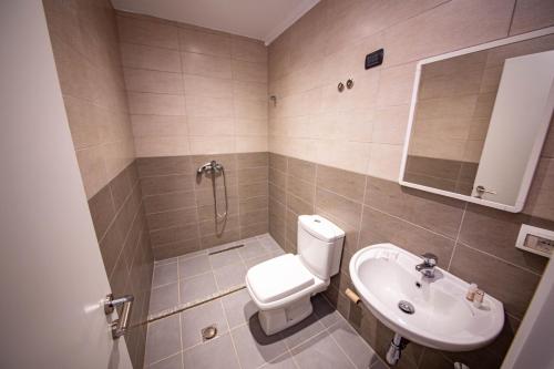 a bathroom with a toilet and a sink at Hotel Miki in Durrës
