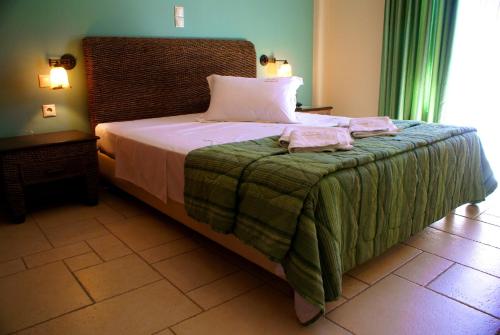 a bedroom with a bed with two towels on it at Xenonas Afroditi in Loutra