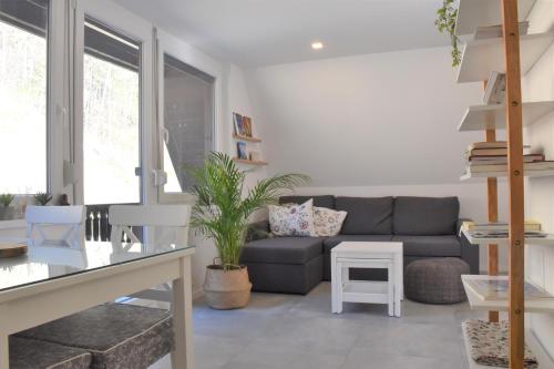 a living room with a couch and a table at Our Forest House in Tržič