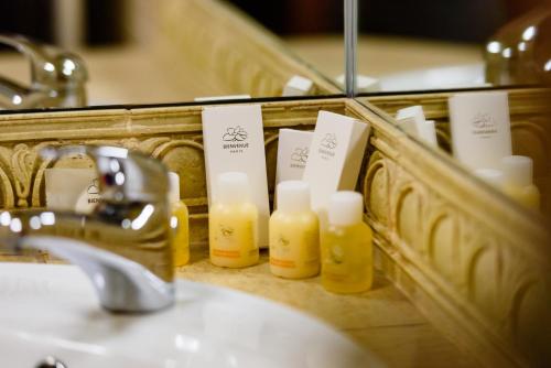 a bathroom mirror with a sink and some candles at Pension Passion in Târgu-Mureş