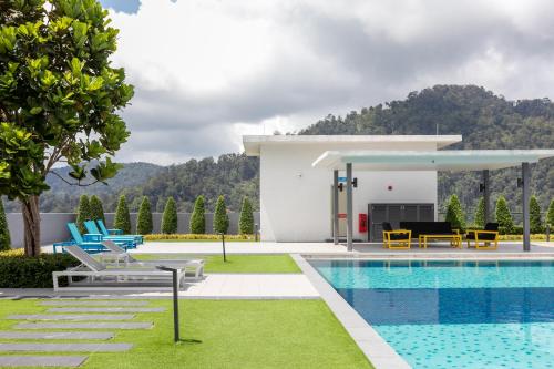a villa with a swimming pool and a resort at Genting Premium Suite Windmill Upon Hills by JAz Home Suites in Genting Highlands