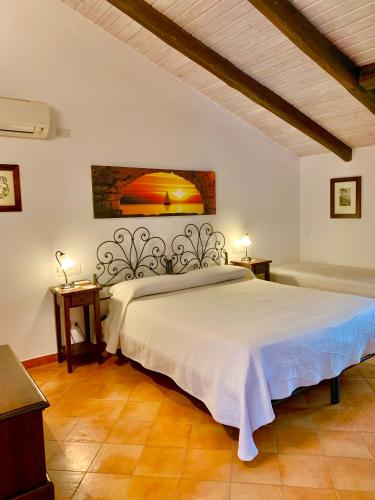 a bedroom with a bed and a painting on the wall at Country house sant alfonso in Furore
