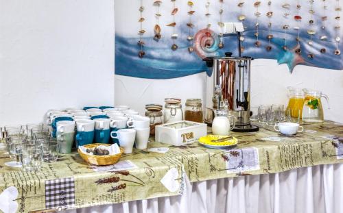 a table with food and drinks on it at Ośrodek Wypoczynkowy CHAMPION in Władysławowo