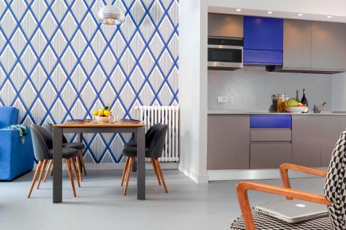 a kitchen and dining room with a table and chairs at SorrentoVibes - Luxury Design Home & Jacuzzi in Heart of Sorrento in Sorrento
