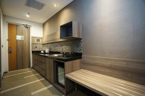 a kitchen with a sink and a counter top at Holiday Inn Bandung Pasteur by IHG in Bandung