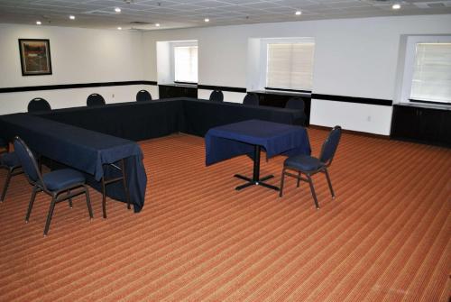 a conference room with a table and chairs in it at Microtel Inn and Suites by Wyndham Toluca in Toluca