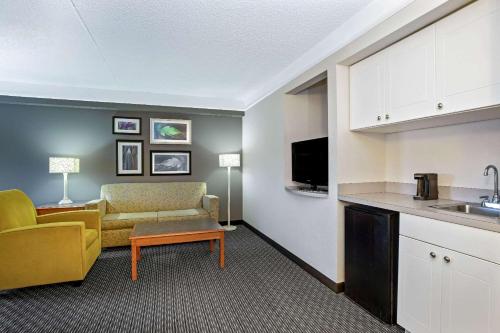 a kitchen and a living room with a couch and a table at La Quinta by Wyndham Tucson Airport in Tucson