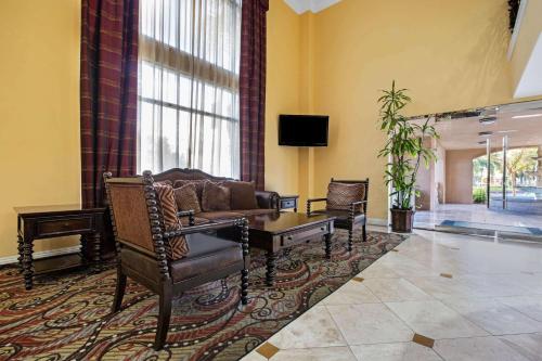 a living room with a couch and a table at La Quinta by Wyndham Moreno Valley in Moreno Valley