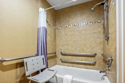 a bathroom with a tub and a toilet and a shower at La Quinta by Wyndham Coeur d`Alene in Coeur d'Alene