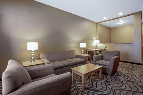 a hotel room with a couch and two chairs and tables at La Quinta by Wyndham Coeur d`Alene in Coeur d'Alene