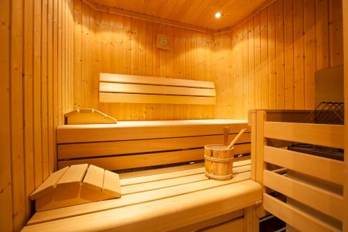 a wooden sauna with a tub and a bucket at Haus Steinbock in Neustift im Stubaital