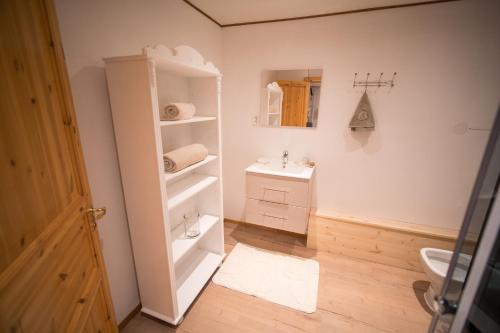 a bathroom with a sink and a toilet and a mirror at The Crush in Ersfjordbotn