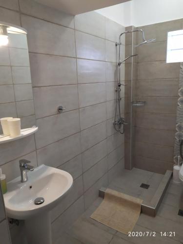a bathroom with a sink and a shower at Ethra luxury studios in Asprovalta
