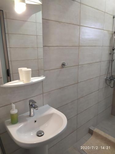 a bathroom with a sink and a mirror at Ethra luxury studios in Asprovalta