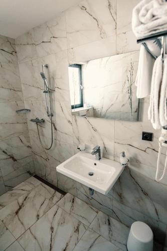 a white bathroom with a sink and a shower at Sousedi Pavlov in Pavlov