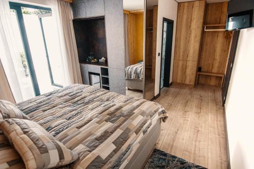 a bedroom with a bed and a large window at Sousedi Pavlov in Pavlov