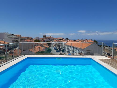 a swimming pool on a balcony with a view of the ocean at Muralha - By SCH in Nazaré