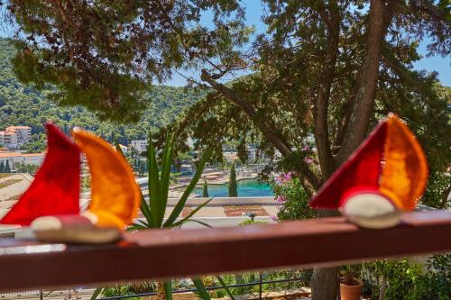 a group of three colorful gnomes sitting on a bench at Apartments Silva in Dubrovnik
