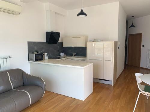 a kitchen with a couch and a counter in a room at Koper Sea Apartment in Koper