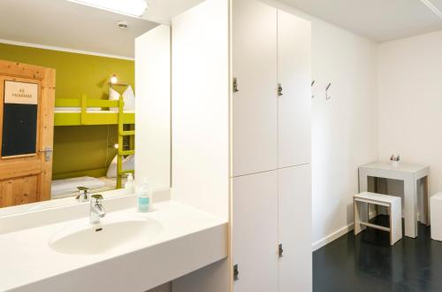 a bathroom with a sink and a mirror at Jugendherberge Lenggries in Lenggries