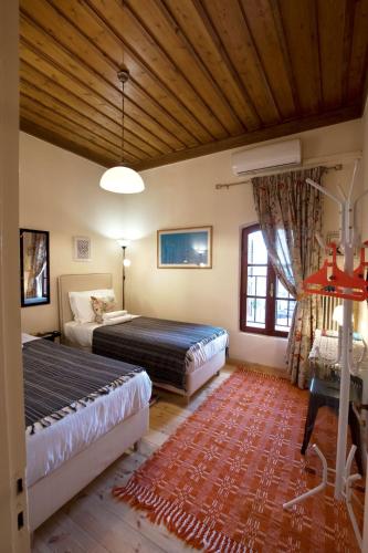 a bedroom with two beds and a wooden ceiling at Chronis Family Villas in Krousón