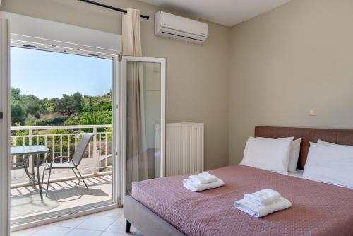 ein Schlafzimmer mit Bett und Balkon mit Aussicht in der Unterkunft Lagadi Apartment 3 in Lassi