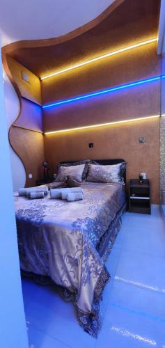 a bedroom with a large bed with a wooden headboard at Yela in Zadar