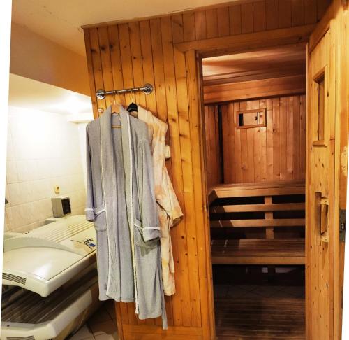 a bathroom with a bed and a towel on a door at Poddasze in Zblewo