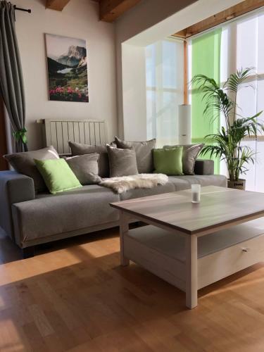a living room with a couch and a coffee table at Zur Weberei in Bad Tölz