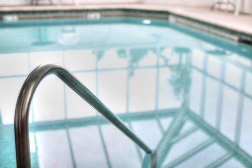 a close up of a swimming pool with a hand rail at The Inn at Apple Valley, an Ascend Collection Hotel in Pigeon Forge