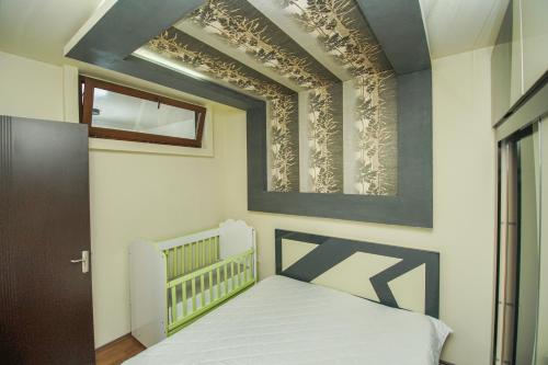 a small bedroom with a bed and a window at jako in Batumi