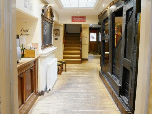a hallway of a store with a door and stairs at The Angel in Wootton Bassett in Royal Wootton Bassett