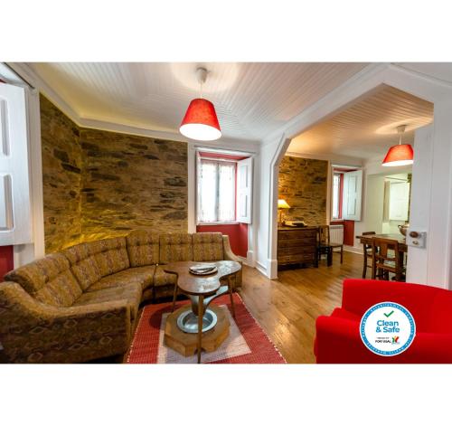 a living room with a couch and a table at Casa do Silverio - Barroca in Barroca