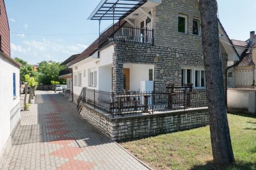 a brick house with a balcony on a street at Müller's 1 in Siófok