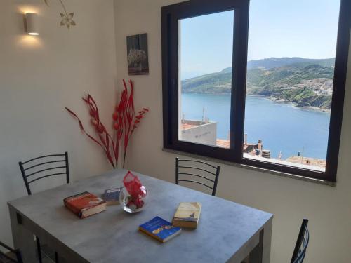 a dining room table with a view of the water at Bellagio in Castelsardo