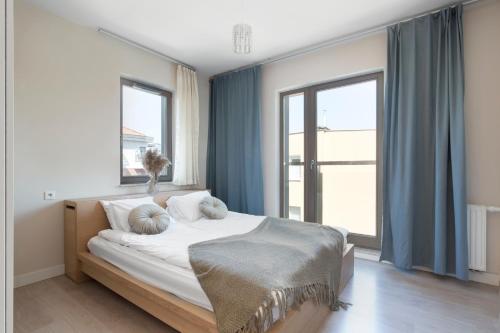 a bedroom with a bed with two pillows on it at Elite Apartments Waterlane Swimming Pool&aSpa in Gdańsk