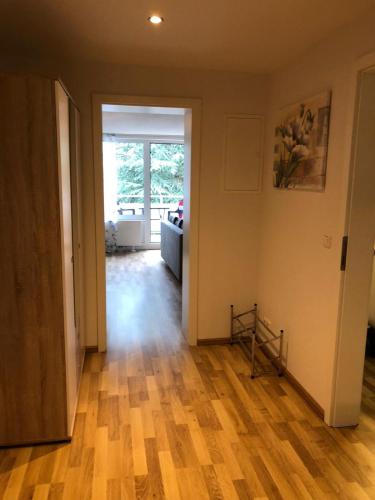 an empty living room with a hard wood floor at Haus Sonnenschein in Timmendorfer Strand