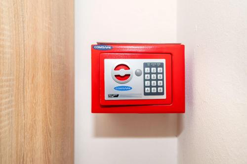 a red wall clock on a white wall at Apartments Jurina 2 in Krk