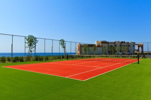 a tennis court in front of a building at Boutique 5 Hotel & Spa - Adults Only in Kiotari