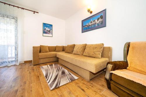 a living room with a couch and a chair at Apartments Jurina in Krk