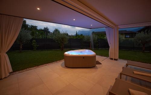 a large patio with a hot tub in the middle of a yard at Penthouse & Garden - luxury apartment in Postal