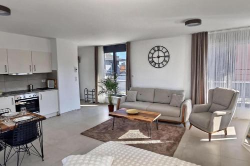 a living room with a couch and a table at KRésidence - Appartements Saint-Louis in Saint-Louis