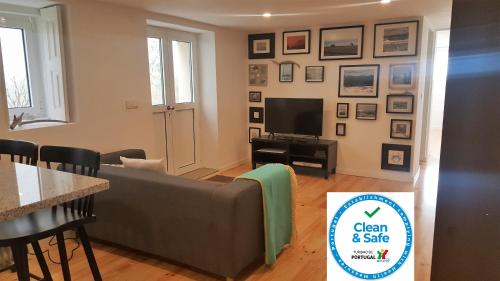 a living room with a couch and a tv at Carmo Apartment in Espinho