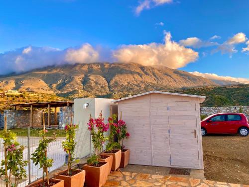 a small shed with a mountain in the background at Villa Thalassa in Triopetra